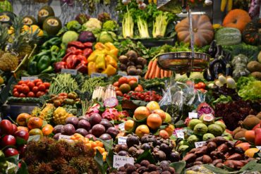 Fresh produce and vegetables displayed at an outdoor farmers market