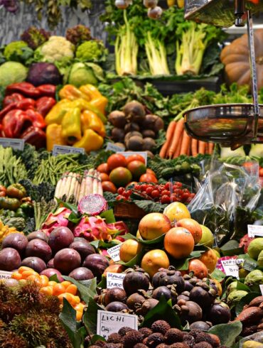 Fresh produce and vegetables displayed at an outdoor farmers market