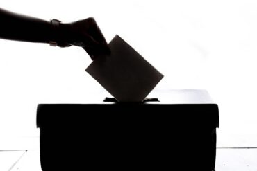 Voters at a ballot box participating in a local election