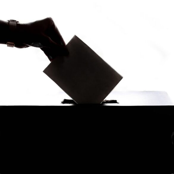 Voters at a ballot box participating in a local election