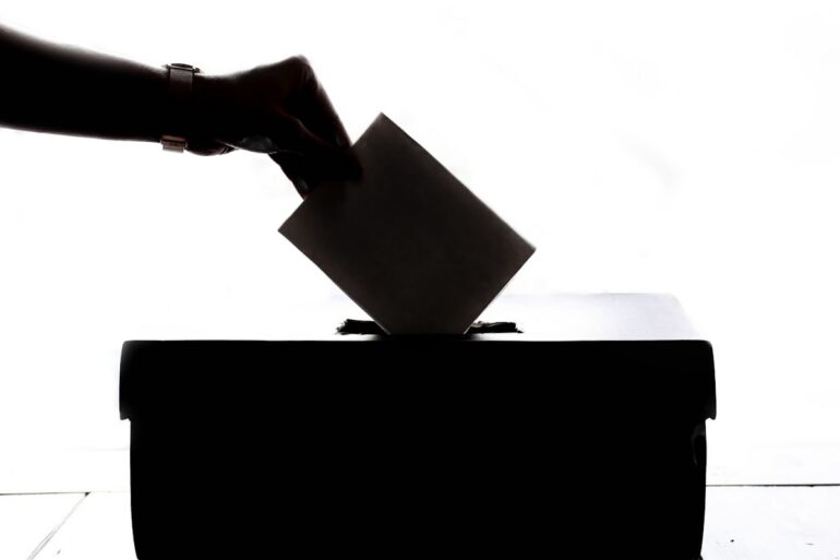 Voters at a ballot box participating in a local election